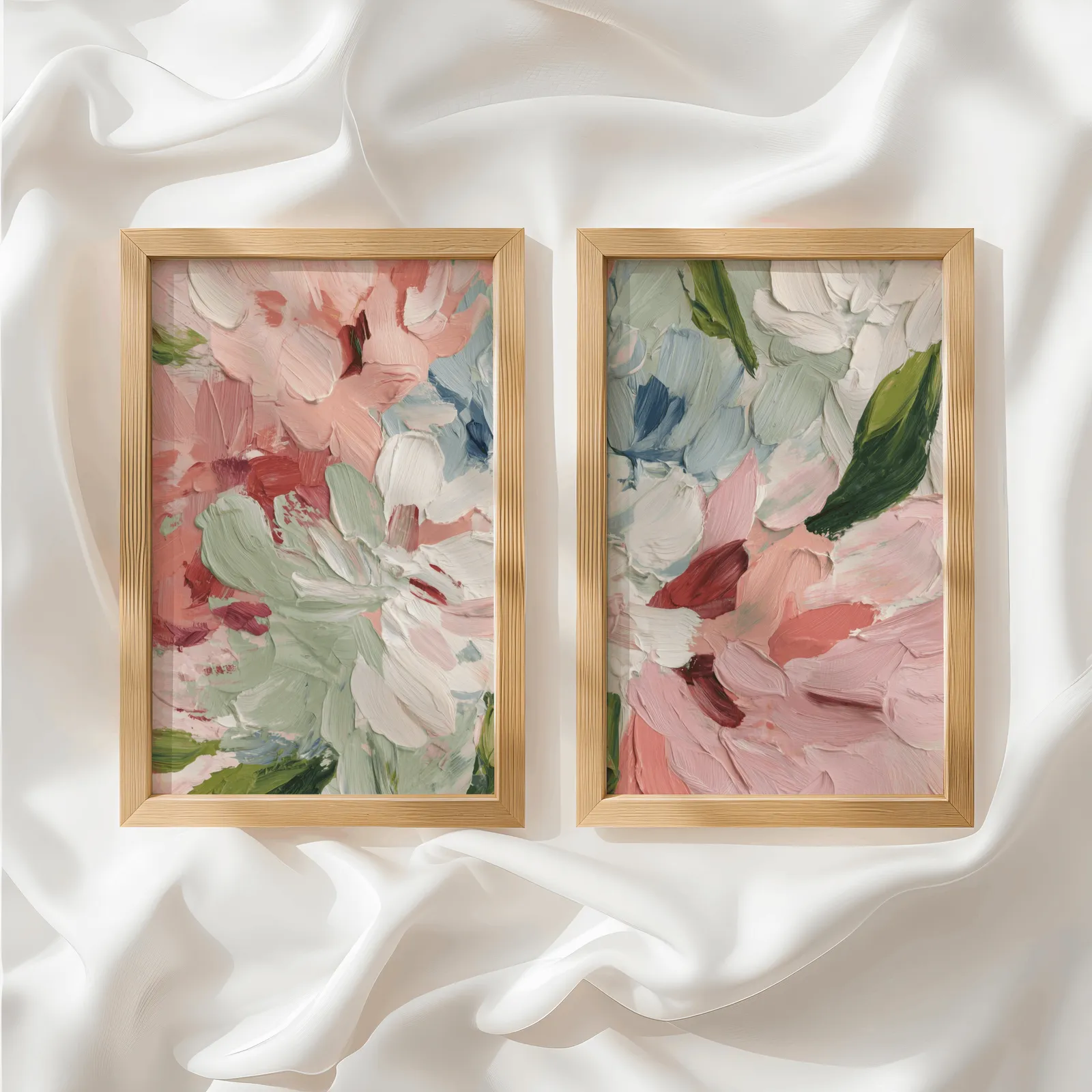 pink abstract floral wall art set of two, side by side atop rumpled white silky fabric